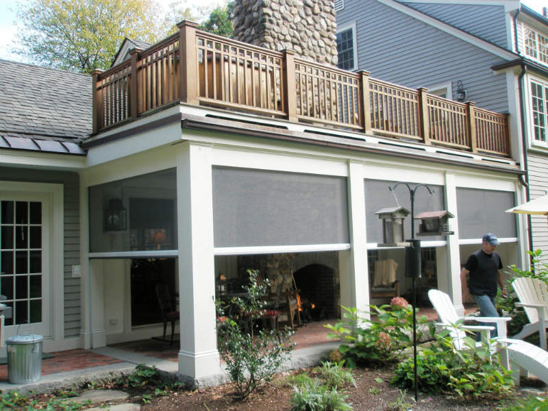 A house with a fireplace and patio furniture.