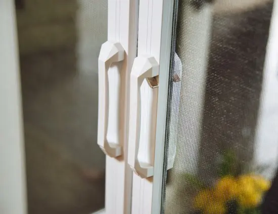 A close up of the handles on a window