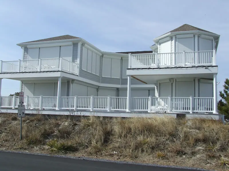 A large white house sitting on top of a hill.