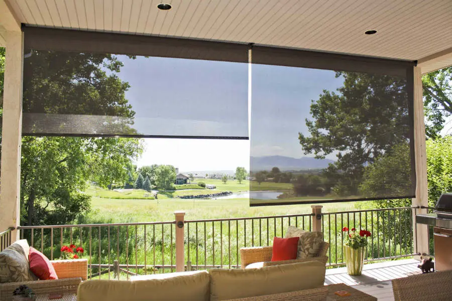 A patio with a couch and table outside