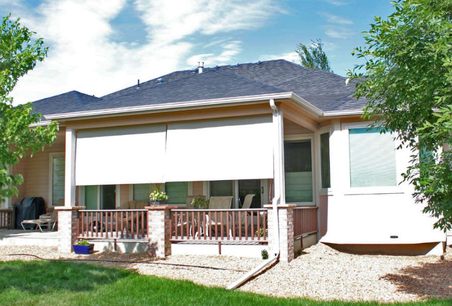 A house with a porch and patio furniture.