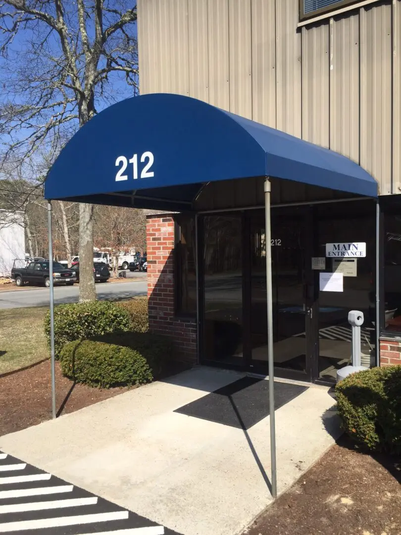 A blue awning is attached to the side of a building.