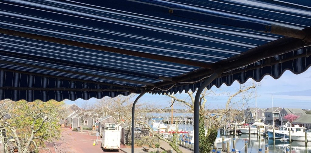 A blue awning over the top of a bus.