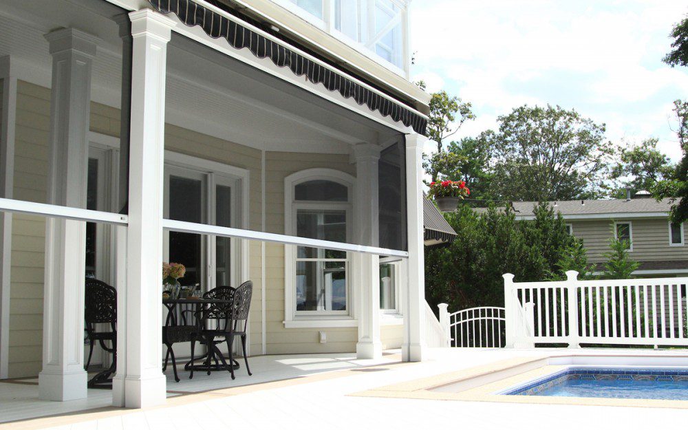 A patio with chairs and tables outside of the house.