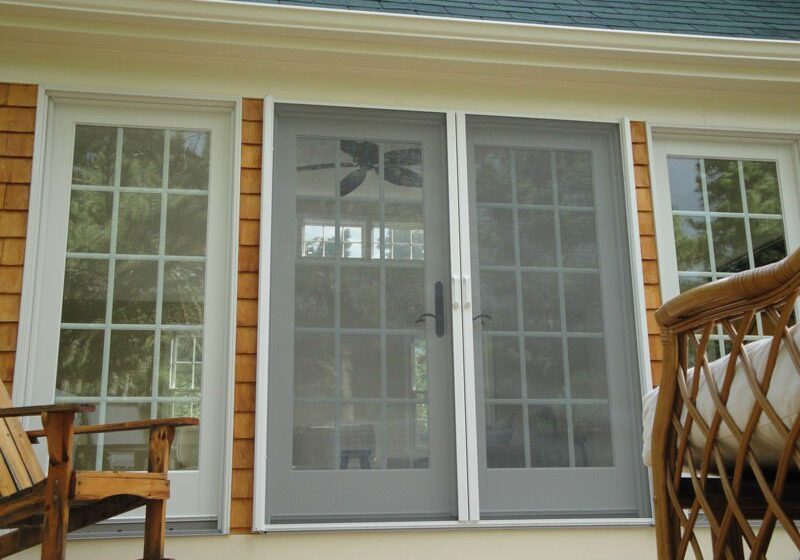 A screen door on the outside of a house.